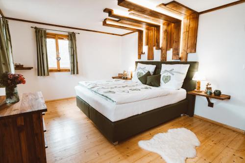 a bedroom with a large bed in a room at Almhaus Rinner in Greith