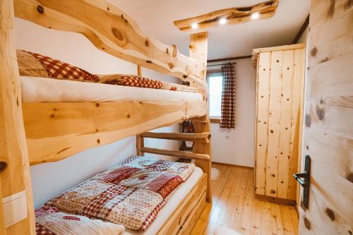 a bedroom with bunk beds in a log cabin at Almhaus Rinner in Greith