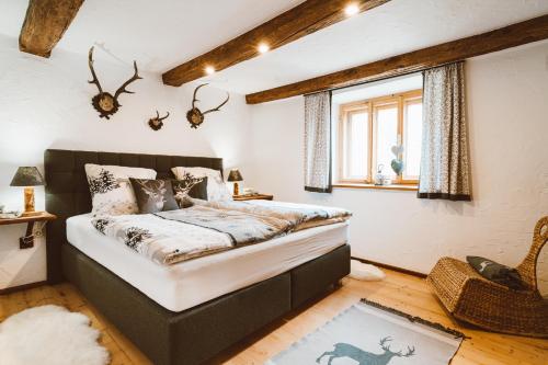 a bedroom with a bed and a window at Almhaus Rinner in Greith