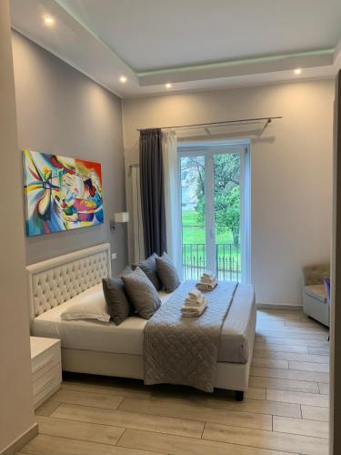 a bedroom with a large bed with a window at ROYAL GARDENS in Caserta