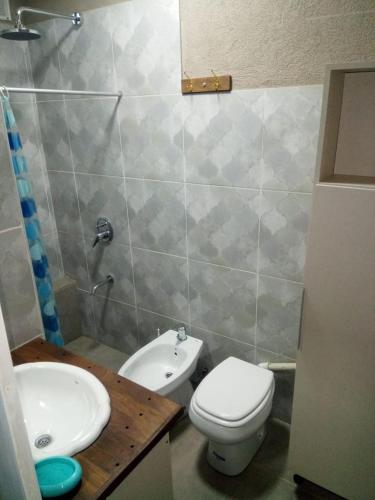 a bathroom with a toilet and a sink at FINCA VERDE in La Falda