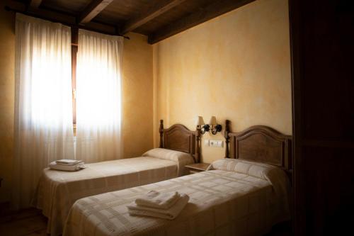 Posteľ alebo postele v izbe v ubytovaní Casa Rural La Tina