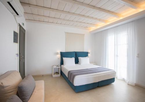 a bedroom with a bed and a couch in a room at Princess Of Naxos in Naxos Chora