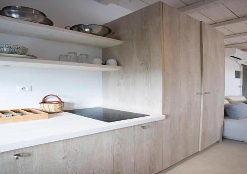 a kitchen with wooden cabinets and a sink at Princess Of Naxos in Naxos Chora