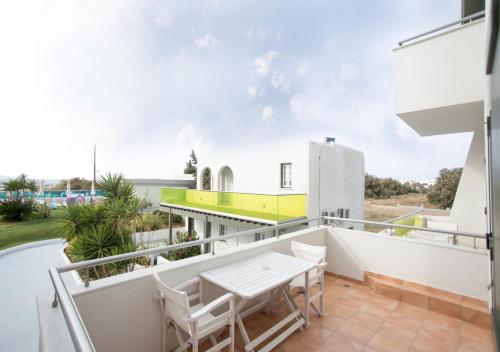 a balcony with a table and chairs on a building at Princess Of Naxos in Naxos Chora
