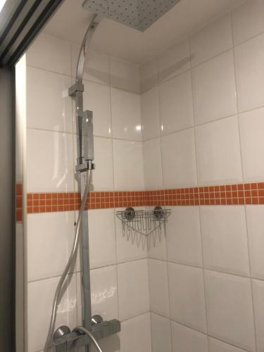 a shower with a hose in a bathroom at Love Chalet in Nancray