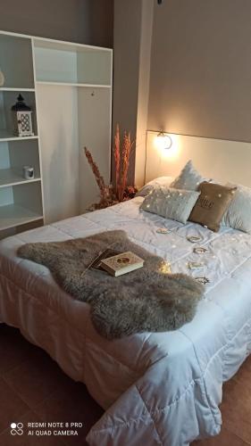 a bedroom with a large bed with a book on it at FINCA VERDE in La Falda