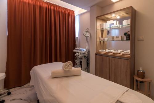 a hospital room with a bed with a towel on it at Daisy resort in Novi Sad