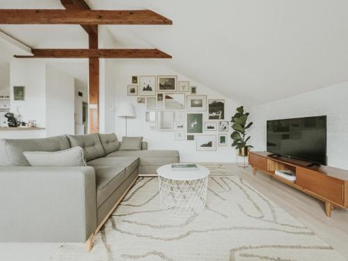 a living room with a couch and a tv at Home in Bled in Bled