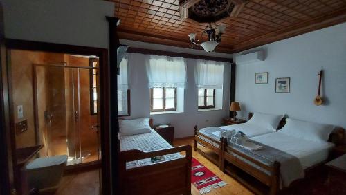 a bedroom with a bed and a sink in it at Timo's Guest House in Berat