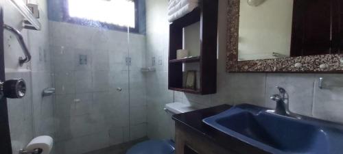 a bathroom with a blue sink and a mirror at Massai Apartments in Playa Flamingo