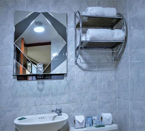 a bathroom with a sink and a mirror at Hotel Plaza San Antonio Arequipa in Arequipa