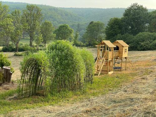 a wooden playground in the middle of a field at Sielska Chyża in Rzepedż