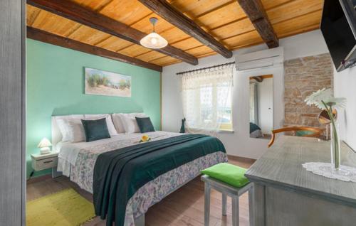 a bedroom with a large bed with green walls at Villa Marko in Buje