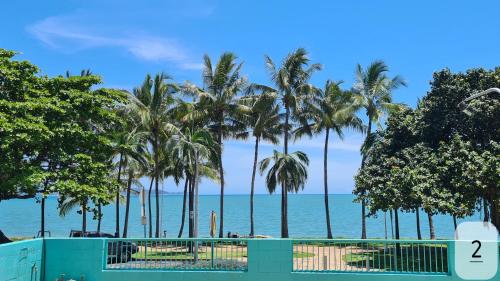 a view of the ocean from a beach with palm trees at Emthree Seaside Apartments in Townsville