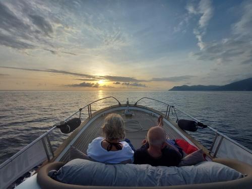 a man and a woman sitting on the back of a boat at Agriturismo Costa di Faraggiana in Levanto