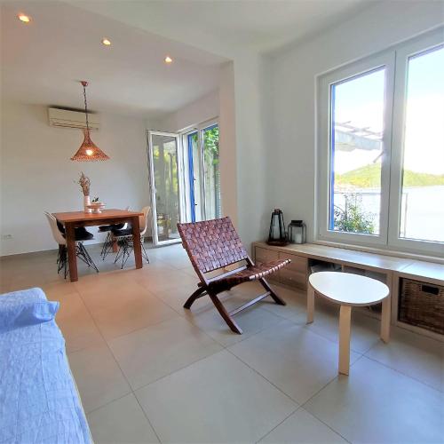 a living room with a chair and a table at Mljet 4You - Beach House in Sobra