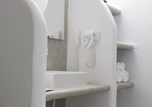a bathroom with a phone in a white wall at Princess Of Naxos in Naxos Chora