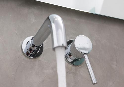 a bathroom sink with a faucet and two spoons at Princess Of Naxos in Naxos Chora
