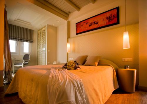 a bedroom with a large bed with flowers on it at Princess Of Naxos in Naxos Chora
