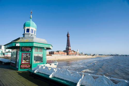 a building on a pier next to the beach at Blackpool North Close to Station - With Free Car Parking in Blackpool