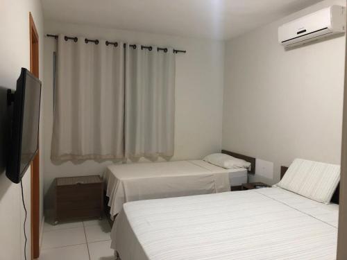 Katil atau katil-katil dalam bilik di Apartamento na Reserva Imbassai