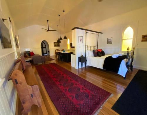 a bedroom with a bed and a living room at The Church at Barrington in Barrington