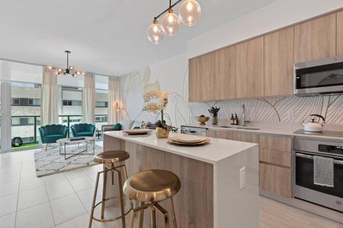 a kitchen with a counter and stools in it at LUXURY 1 BDRM/1B APT IN MIAMI DESIGN DISTRICT AREA in Miami