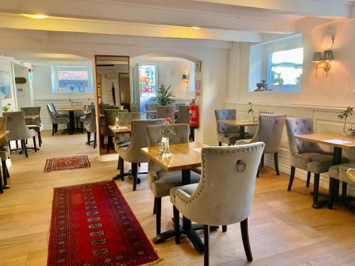 um restaurante com mesas e cadeiras e um tapete vermelho em Hotel Concordia em Lund