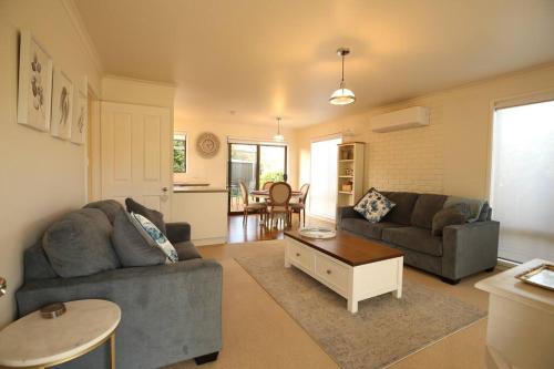a living room with a couch and a table at Bridgecroft Cottage in Richmond