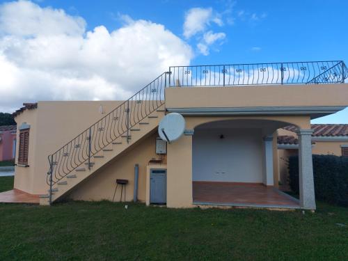 a house with a staircase on top of it at Gallura Dream villas in Budoni