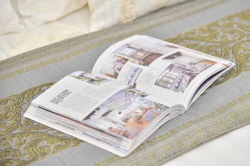 a magazine sitting on top of a table at Silsopa Hostel in Nong Khai