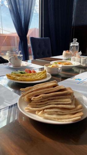 a table with plates of food on top at Hotel & Resort Golden Marina Yanbu in Yanbu