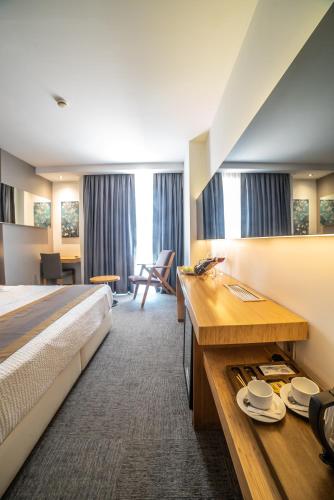 a hotel room with a bed and a desk at Atik Hotel in Unye