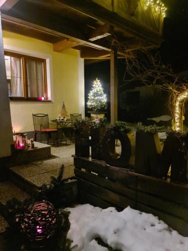 a living room with a christmas tree in the background at Ferienwohnung Huber in Söll