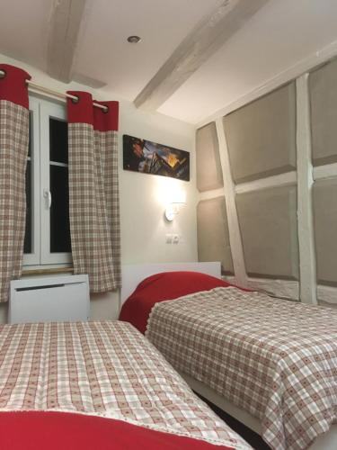 une chambre d'hôtel avec deux lits et une fenêtre dans l'établissement Gîte chez 