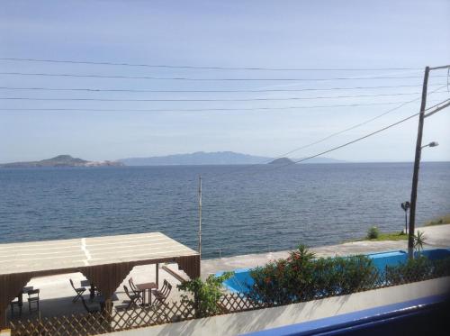 a view of the ocean from the balcony of a house at Haritos Hotel - Geothermal Hot Swimming Pool in Mandrakion