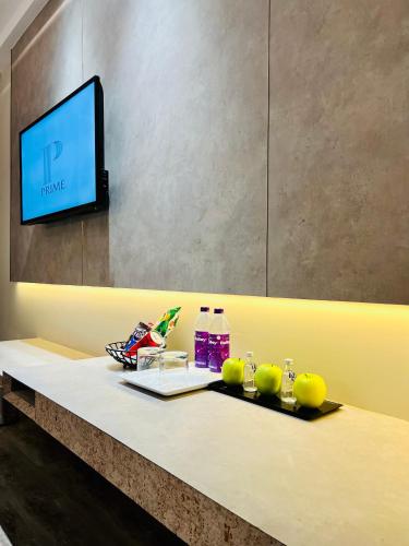 a table with a flat screen tv on top of it at The Prime Delhi - Luxe Collection Hotel in New Delhi