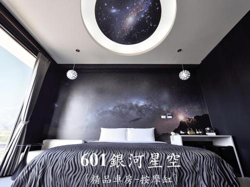 a bedroom with a black and white bed and a window at CoCo Motel Boutique in Puli