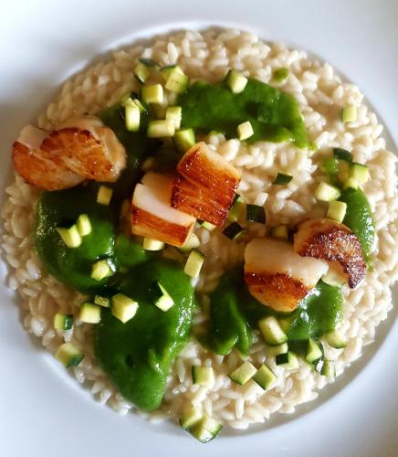 a plate of food with rice and vegetables on it at Ciasa Alpina Relax Hotel in Moena