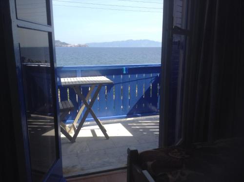 a view of the ocean from the balcony of a house at Haritos Hotel - Geothermal Hot Swimming Pool in Mandrakion
