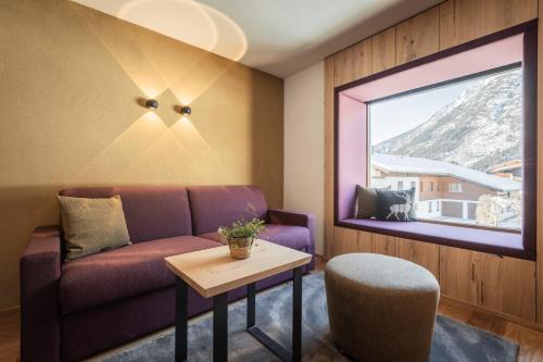 a living room with a couch and a table at Biohotel Leutascherhof in Leutasch