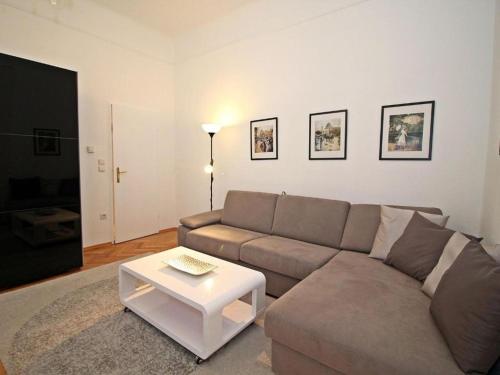 a living room with a couch and a table at Ferienwohnung Kings in Vienna