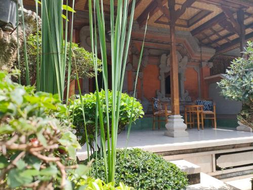 a patio with plants and a table and chairs at Dika Accommodation Ubud in Ubud