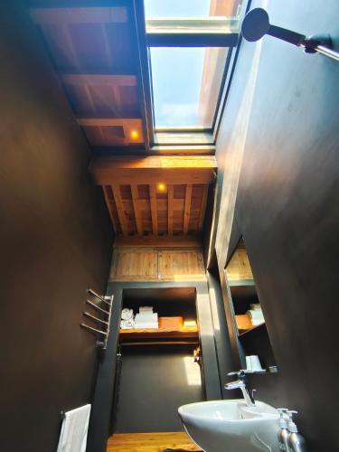 a bathroom with a sink and a window at CMYK Stoneyards by the Great Wall in Huairou
