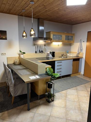 a kitchen with a table and a counter top at Südhang FeWo in Murau