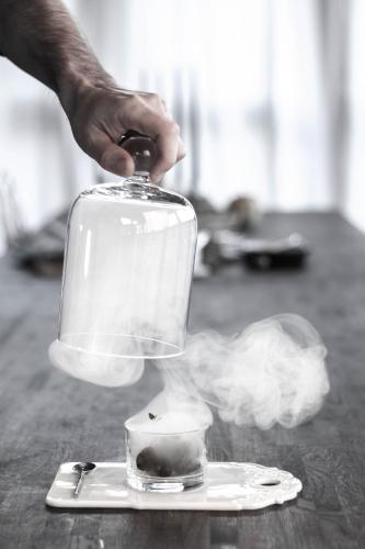 a hand is holding a blender on a table at SOEDER Countryhouse & Kitchen in Båstad