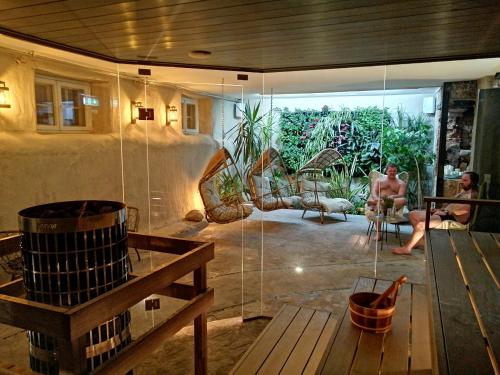 a man sitting in a room with a glass wall at Kernu Manor Hotel & SPA in Kernu