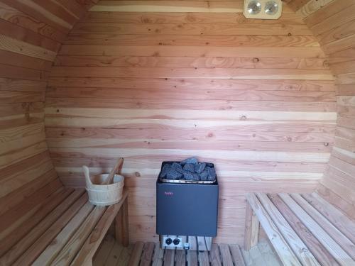 a inside of a wooden cabin with a trash can at Algarte Guest House in Madzhare