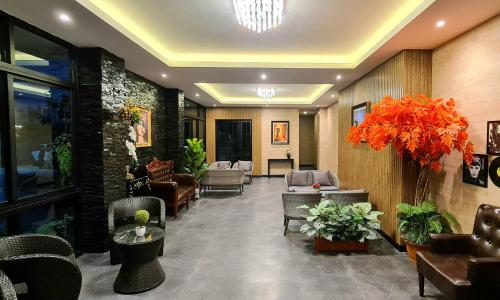 a lobby with chairs and couches in a building at The Room Boutique Hotel in Sakon Nakhon